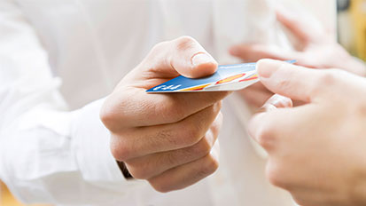 Shell Prepaid Card wird von einer Hand in die andere Hand gegeben. Nutzung zur Motivation für besondere Anlässe.